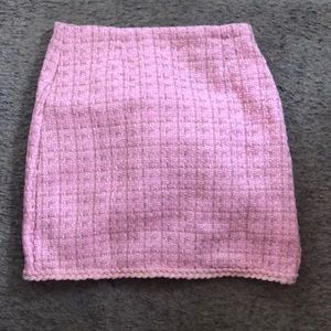 This is a tweed skirt that is pink and is a small/medium